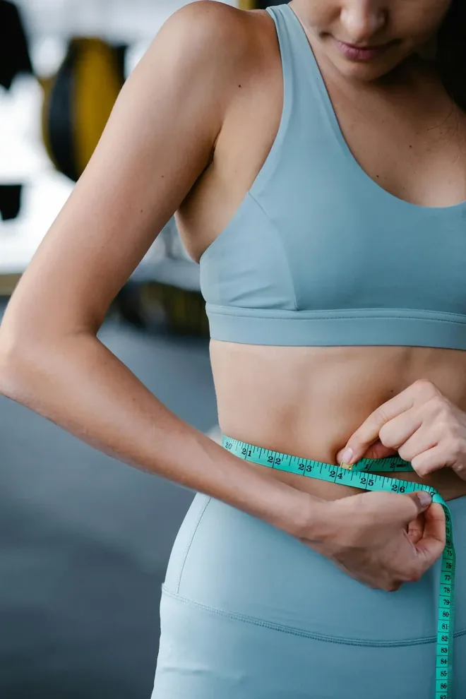 A tape measure held at the waist