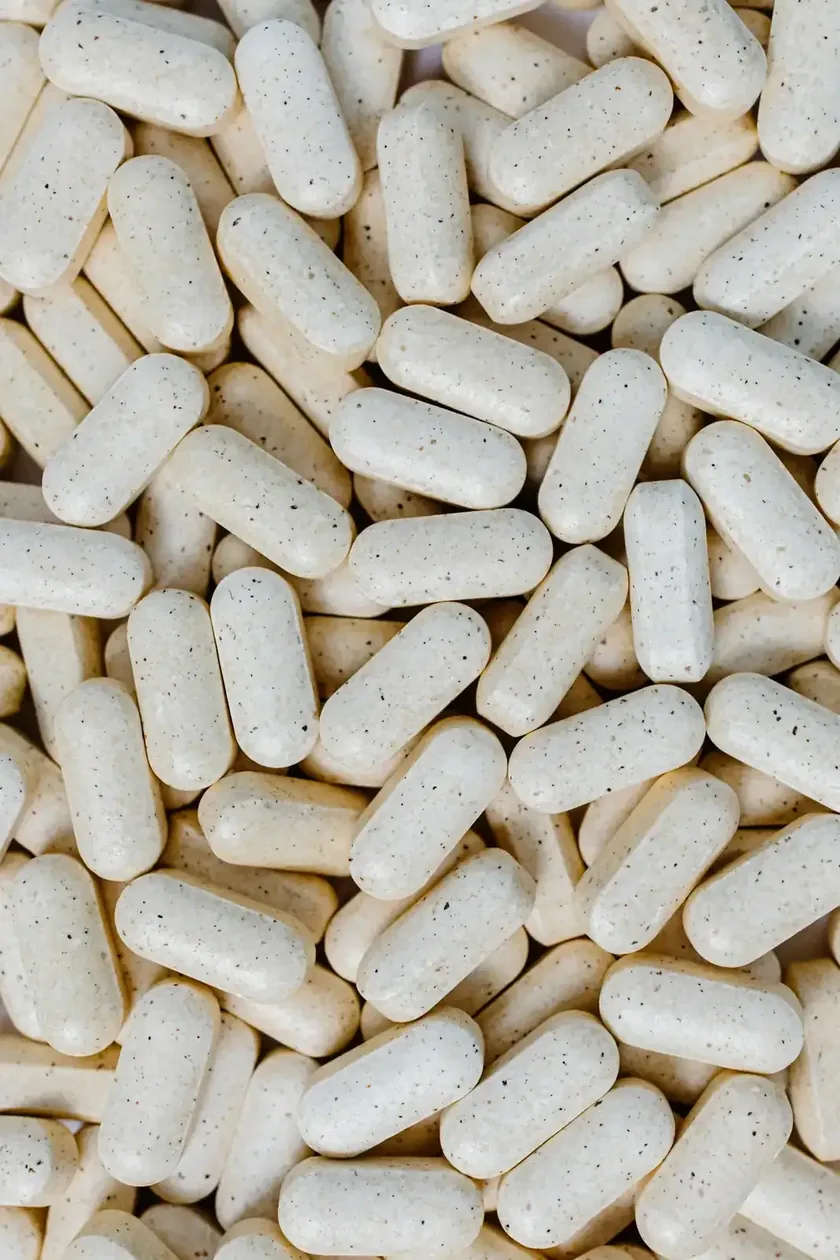 A pile of white capsules representing beta-hydroxybutyrate salts